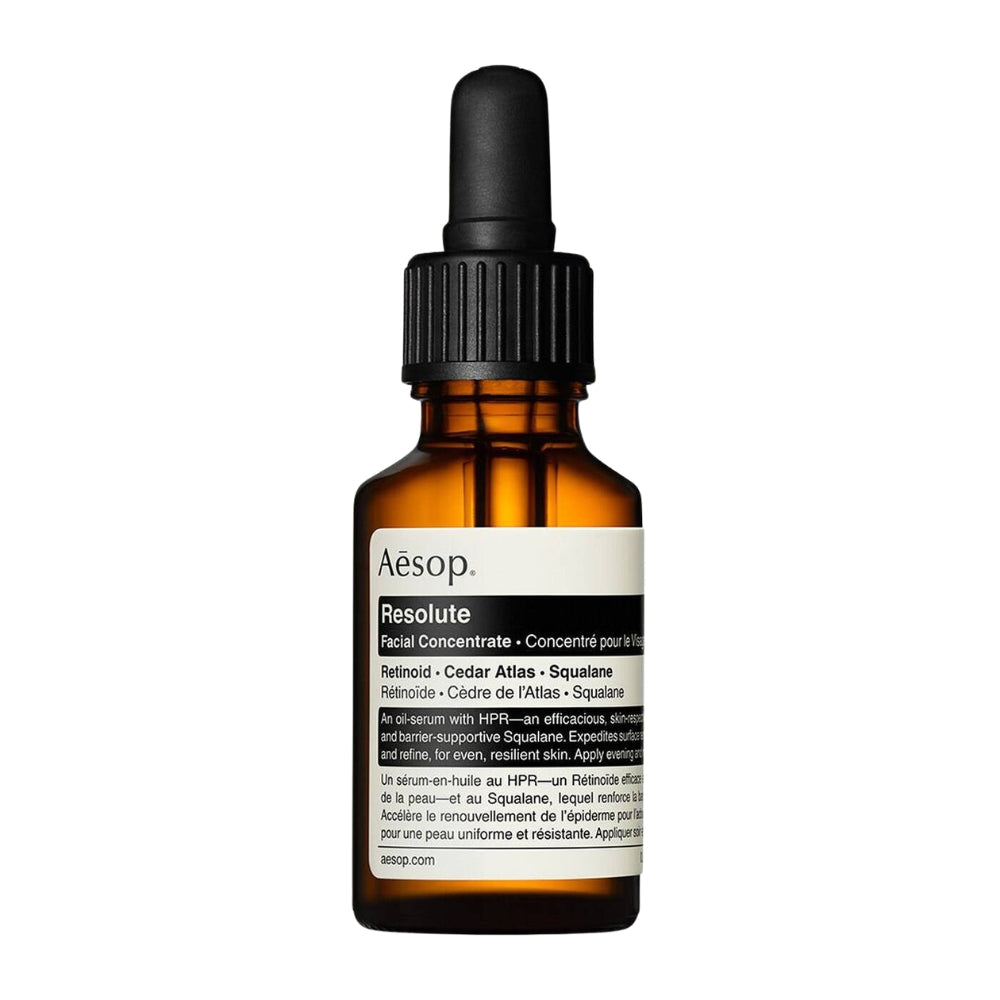Aesop Resolute facial concentrate in an amber glass dropper bottle with a black cap and white label, shown on a plain white background.